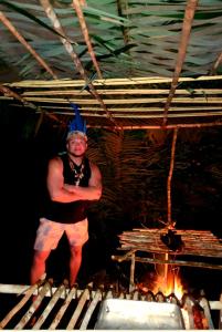 a man standing in front of a fire at Ponta Poranga Jungle Lodge in Manaus