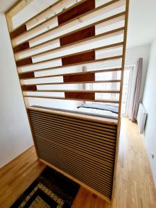 a large wooden wall in a room with wood floors at Open View City Apartment in Vienna