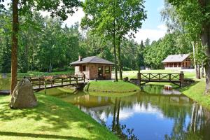 a bridge over a pond in a park at Auksinis Ąžuolas in Avižieniai