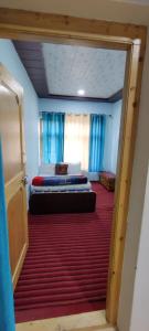 a view of a room with two beds in it at Nakpo Homestay in Leh