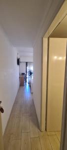 an empty room with a hallway with a door and a floor at Hotel Soleares in Mar del Plata