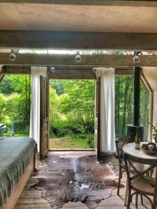 a bedroom with a bed and a table and a window at Hygge Chalet 