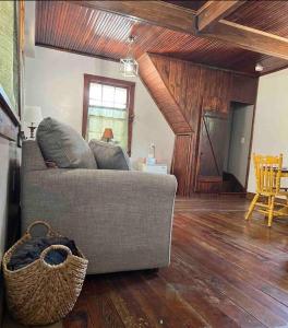 a living room with a couch and wooden floors at Hanna’s Cottage-Downtown Hermann in Hermann