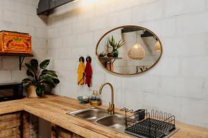 a kitchen with a sink and a mirror at Sea Siren in Paternoster