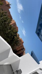 a view of a building and a blue sky at Appartement avec piscine in Pont Blondin