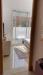 a room with a large glass door with a window at Appartement avec piscine in Pont Blondin