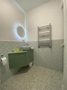 a bathroom with a green sink and a mirror at Guesthouse SHAMPRIANI in Mestia +49 photos