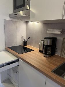 a kitchen with a counter top with a coffee maker at Quartier Südstrand - Ferienwohnung mit Meerblick in Fehmarn