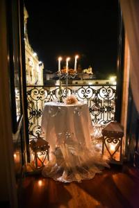a table with two candles on a balcony at night at Il Pregio in Ostuni