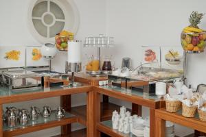 a kitchen with two tables with food on them at Zoe's Club in Spetses