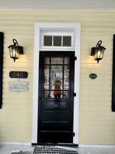 a black door on the front of a house at Heritage House Niagara in Niagara on the Lake