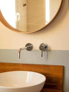 a bathroom with a white sink and a mirror at oYo APARTMENTS in Kortrijk +12 photos