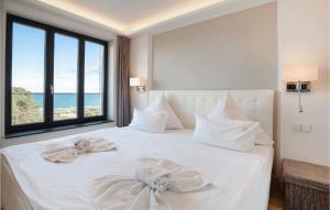 a bedroom with a white bed with two towels on it at Prince in Binz +37 photos