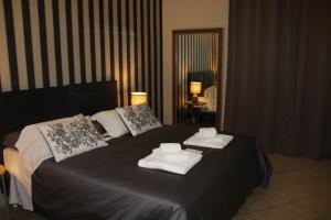 カターニアにあるホテル トリエステのベッドルーム1室(タオル付)
