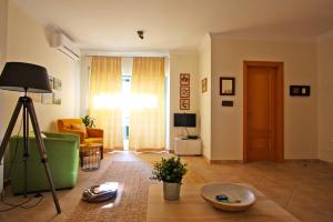 a living room with a green couch and a table at Apartamento Oliveira in Santa Luzia