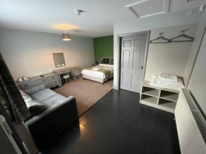 a bedroom with a bed and a couch in a room at The Black Horse Inn in Gainsborough +28 photos