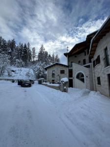 a snow covered street in front of a house at La Loggia Luxury in Rocca di Mezzo