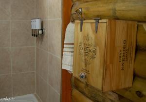 a wooden bag hanging on the wall of a bathroom at Rincón Lejano in Potrerillos +64 photos