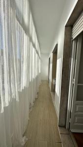 a hallway with white curtains on the wall at Coral Apartment in Lisbon