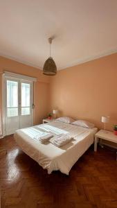 a bedroom with a large white bed in a room at Coral Apartment in Lisbon