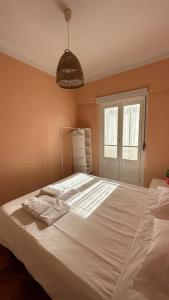 a bedroom with a white bed with towels on it at Coral Apartment in Lisbon
