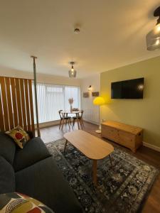 a living room with a couch and a table at Kittiwake Number 4A - Town Centre Ground Floor in Bridlington