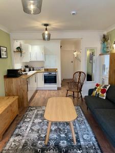 a living room with a couch and a table at Kittiwake Number 4A - Town Centre Ground Floor in Bridlington