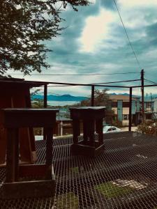 a patio with two benches and a view of a city at El Carretero in Ushuaia