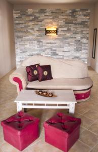 a living room with a couch and a table at Lharmonie Villa in Pereybere