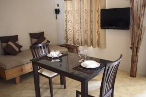 a dining room with a table and a couch at Lharmonie Villa in Pereybere