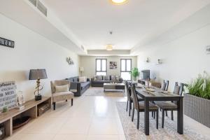 a living room with a table and chairs at Balqis Residense Palm Jumeirah,Pool, Beach, Top floor, Full sea view, Restaurants in Dubai