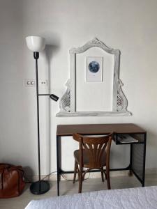 a desk with a chair and a lamp and a picture at La Cuadra de Pascuala in Tajace de Abajo