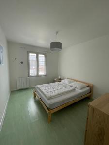a bedroom with a large bed in a white room at Nice 120m with garden near the sea in Sainte-Marie-de-Ré