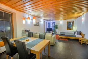 a living room with a dining table and a bedroom at Bungalov Komfort in Liptovský Mikuláš