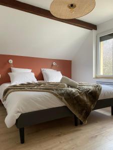 a bedroom with a large bed and a ceiling fan at L'Augustine - Spa privé & Vue Montagne in Saint Avre la Chambre
