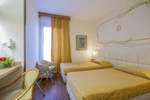 Postel nebo postele na pokoji v ubytování Hotel Delta Florence