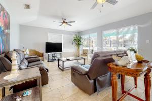 a living room with a couch and a tv at Beach House #0229 in South Padre Island