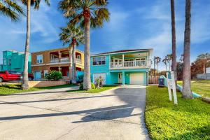 a blue house with palm trees in front of it at Beach House #0229 in South Padre Island