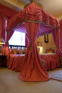 a large bed with a canopy on top of it at Maranatha Country House in Blarney