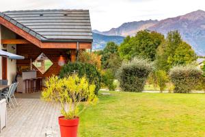 a house with a patio with a view of the mountains at Maison dans les Alpes - Gîte les 12 sommets in Ponsonnas