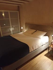 a bedroom with a large bed with a window at Caveau Contemporain KV'O37 in Arbois