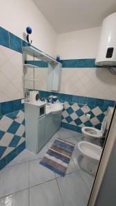 a bathroom with a sink and a toilet at Residenza La Gazza e Spiaggia in Cervia +17 photos