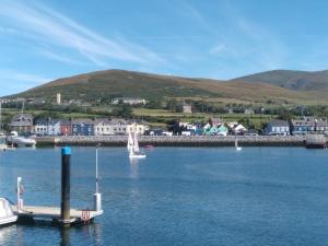 a dock in a body of water with boats in it at The Dingle Galley in Dingle