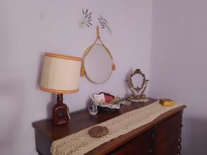 a table with a lamp and a mirror on it at Majella National Park La Casa Di Nonna Maria in Caramanico Terme