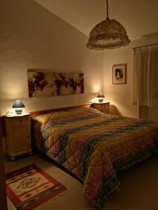 a bedroom with a bed and two tables and two lamps at Il canto dell'asino in Gubbio
