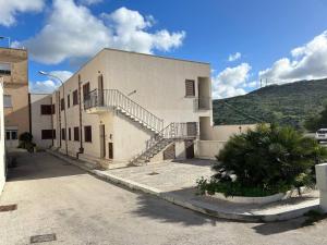 a large building with stairs on the side of it at Case Vacanza Santoro in Custonaci