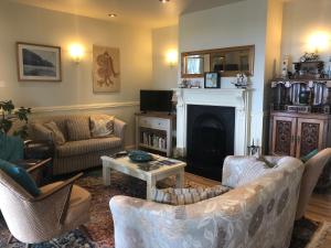 a living room with two couches and a fireplace at Teach Cruachan Bed and Breakfast in Dooagh