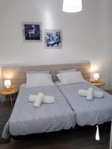 a bedroom with a large bed with two white pillows at Apartamento Balsa 2 in Viseu