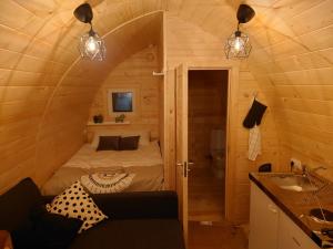 a small room with a bed in a tiny house at Hobbit Hut in Hallstahammar