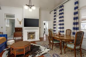 a living room with a table and a fireplace at Celestine Bed and Breakfast in Pensacola